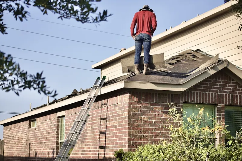 Professional roofer working on a residential roof in Fernridge Place